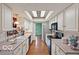 Well-lit kitchen with white cabinetry and stainless steel appliances at 813 Boulder Rd, Indianapolis, IN 46217