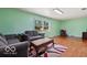 Cozy living area featuring hardwood floors, comfortable seating, and a large window offering natural light at 813 Boulder Rd, Indianapolis, IN 46217