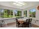 Sunroom with many windows and a table to the outdoor views at 813 Boulder Rd, Indianapolis, IN 46217