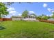 A beautifully lawned backyard featuring a screened in porch, wood deck and privacy fence at 823 W 200 N, Greenfield, IN 46140
