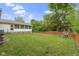 Spacious backyard featuring a lush lawn, wood fence and playground at 823 W 200 N, Greenfield, IN 46140