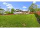 A spacious backyard with a well-manicured lawn, a deck, a porch, and a charming pergola at 823 W 200 N, Greenfield, IN 46140
