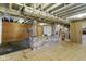 Unfinished basement with brick accents, low ceiling, and exposed utilities at 823 W 200 N, Greenfield, IN 46140