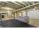 Unfinished basement with black rubber floor, bar, and exposed utilities at 823 W 200 N, Greenfield, IN 46140