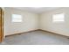 Bright bedroom with two windows, neutral walls, and gray carpet flooring at 823 W 200 N, Greenfield, IN 46140