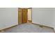 Neutral bedroom featuring plush gray carpet, wood trim, and natural wood doors at 823 W 200 N, Greenfield, IN 46140