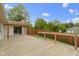 Wood deck and backyard with lush trees and blue sky at 823 W 200 N, Greenfield, IN 46140