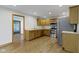 Spacious kitchen features wood cabinets, stainless steel appliances, and a hardwood floor at 823 W 200 N, Greenfield, IN 46140