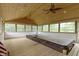 Indoor sunroom featuring ceiling fans, a hot tub, and wood paneled ceiling at 823 W 200 N, Greenfield, IN 46140