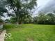 Spacious backyard with green grass and mature trees at 907 Monroe St, Indianapolis, IN 46229