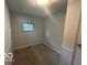 Neutral bedroom with a window, carpeted floor, and white trim at 907 Monroe St, Indianapolis, IN 46229