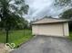 Detached garage with a paved driveway and backyard at 907 Monroe St, Indianapolis, IN 46229