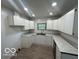 Functional kitchen featuring white cabinets, laminate countertops, and recessed lighting at 907 Monroe St, Indianapolis, IN 46229