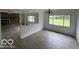 Bright and airy living area showcasing laminate flooring and a partial stone fireplace at 907 Monroe St, Indianapolis, IN 46229