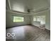Bright and airy living area featuring laminate flooring and large windows at 907 Monroe St, Indianapolis, IN 46229
