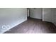 Spacious living room featuring laminate flooring and neutral paint at 907 Monroe St, Indianapolis, IN 46229