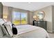 An inviting bedroom offers views of the neighborhood with a comfy bed and a dark dresser at 918 Norfolk Ln, Greenwood, IN 46143