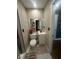 This is a cozy bathroom featuring a vanity, mirror, toilet with flowers and tiled walls at 9527 Pepperidge Dr, Indianapolis, IN 46235