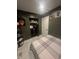 Inviting bedroom with an open closet, decorative wall art, and neutral-toned furnishings at 9527 Pepperidge Dr, Indianapolis, IN 46235