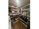 A spacious walk-in closet with custom shelving, hanging racks and organized storage for clothes and accessories at 9527 Pepperidge Dr, Indianapolis, IN 46235