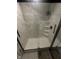 Modern shower featuring marble-style tile walls, glass enclosure, and convenient built-in shelves at 9527 Pepperidge Dr, Indianapolis, IN 46235