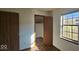 Bedroom with view to walk-in closet with hardwood floors and a window at 9730 English Oak Pl, Indianapolis, IN 46235