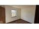 Clean and simple bedroom with hardwood floors and a window allowing natural light at 9730 English Oak Pl, Indianapolis, IN 46235
