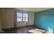 This sunny bedroom features a large window, wood-look floors, and neutral walls at 9730 English Oak Pl, Indianapolis, IN 46235