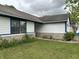 View of the home's side exterior showcasing the window, stone facade, and well-kept lawn at 9730 English Oak Pl, Indianapolis, IN 46235