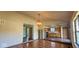 Open-concept living room with hardwood floors and views into the adjacent kitchen area at 9730 English Oak Pl, Indianapolis, IN 46235