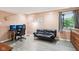 Finished basement with light pink wall, desk, and pull out couch at 976 Santa Maria Dr, Greenwood, IN 46143