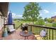 Wooden deck with comfortable chairs, a table, and grill, overlooking a well-kept lawn and pond at 976 Santa Maria Dr, Greenwood, IN 46143
