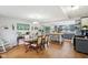 Bright dining area adjacent to a spacious kitchen with wood floors and modern pendant lighting at 976 Santa Maria Dr, Greenwood, IN 46143