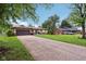 Single-story home with a long driveway, lush lawn, and mature trees offering shade at 976 Santa Maria Dr, Greenwood, IN 46143