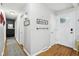 Bright hallway with wood floors leading to a front door and tastefully decorated walls at 976 Santa Maria Dr, Greenwood, IN 46143