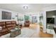 Open-concept living room with wood floors, comfortable seating, and a glimpse of the kitchen at 976 Santa Maria Dr, Greenwood, IN 46143
