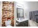 Cozy bathroom features a vanity with sink, decorative mirror, and wood-look accent wall at 9771 Blue Violet Dr, Noblesville, IN 46060