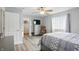 Inviting bedroom featuring a ceiling fan, closet, TV, and light colored, wood-look floors at 9771 Blue Violet Dr, Noblesville, IN 46060