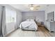Comfortable bedroom features a ceiling fan, window with beautiful natural light, and hardwood floors at 9771 Blue Violet Dr, Noblesville, IN 46060