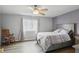 Cozy bedroom features a ceiling fan, large window with beautiful natural light, and hardwood floors at 9771 Blue Violet Dr, Noblesville, IN 46060