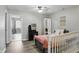 Cozy bedroom features a cute vanity, a decorative mirror, a comfortable bed, and an attached room at 9771 Blue Violet Dr, Noblesville, IN 46060