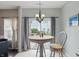 Bright breakfast nook featuring a table with chairs, a window, and sliding glass doors to the backyard at 9771 Blue Violet Dr, Noblesville, IN 46060