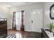 Bright entryway featuring hardwood floors, a front door with glass panels, and elegant decor at 9771 Blue Violet Dr, Noblesville, IN 46060