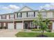 Inviting townhome with brick and siding exterior, attached garage, and well-maintained front yard landscaping at 9771 Blue Violet Dr, Noblesville, IN 46060
