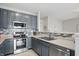 Modern kitchen with stainless steel appliances, stylish backsplash, and ample cabinet space at 9771 Blue Violet Dr, Noblesville, IN 46060