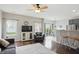 Stylish living room with a large window, ceiling fan, and sliding glass doors to the outdoor patio at 9771 Blue Violet Dr, Noblesville, IN 46060