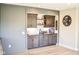 Charming bar area features a patterned backsplash, dark cabinetry, and a dedicated space for displaying favorite items at 987 Oak Terrace Rd, Westfield, IN 46074