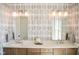 Elegant bathroom with dual sinks, stylish mirrors, and designer wallpaper for a spa-like experience at 987 Oak Terrace Rd, Westfield, IN 46074