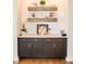 Stylish countertop area with dark cabinets, open shelving, and decorative elements, adding character to the space at 987 Oak Terrace Rd, Westfield, IN 46074