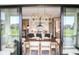 A dining room features a view into the kitchen with an outdoor patio view at 987 Oak Terrace Rd, Westfield, IN 46074